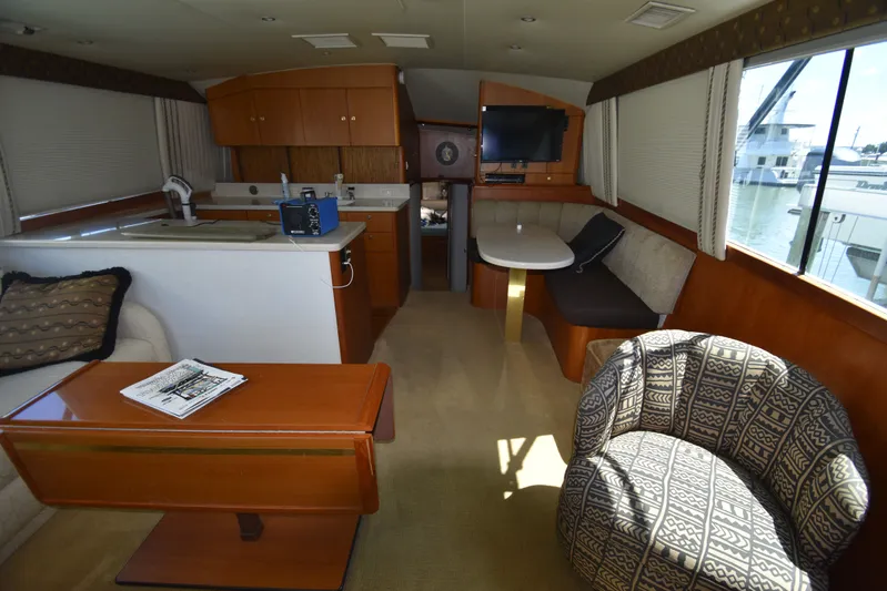 Whaler Yacht Photos Pics Interior of a 1997 Ocean 48 Convertible yacht with cozy seating area.