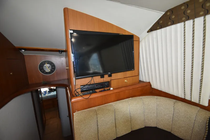 Whaler Yacht Photos Pics Interior of 1997 Ocean 48 Convertible yacht with TV and seating area.