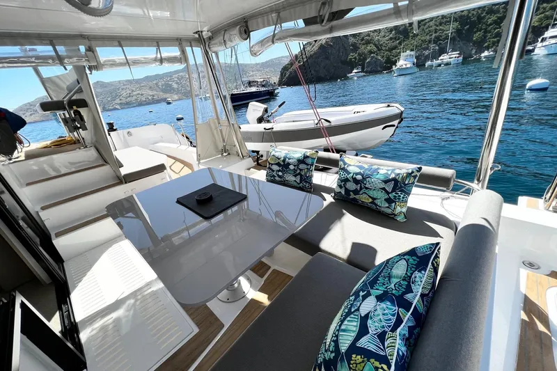 Keizan Yacht Photos Pics Luxurious NEEL 43 yacht interior with stylish seating, table, and scenic ocean view, 2023 model.