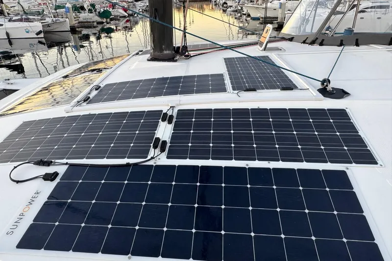 Keizan Yacht Photos Pics Solar panels on a 2023 NEEL 43 trimaran, docked at a marina.