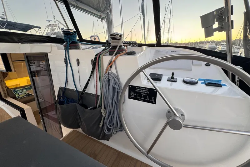 Keizan Yacht Photos Pics Helm of 2023 NEEL 43 trimaran with ropes and navigation controls at sunset.