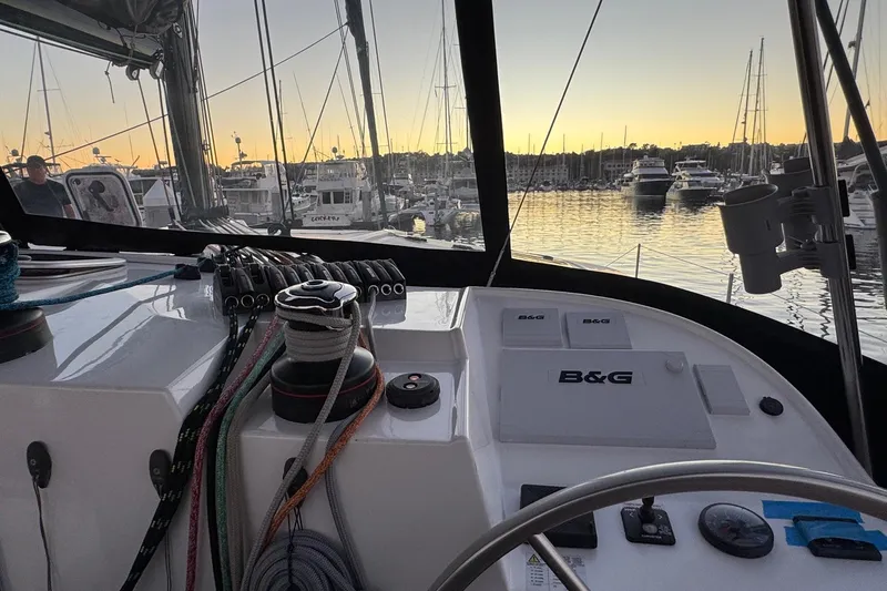 Keizan Yacht Photos Pics Cockpit view of 2023 NEEL 43 trimaran at sunset in a marina.
