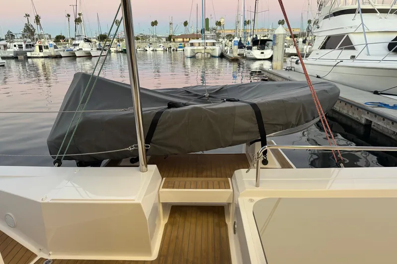 Keizan Yacht Photos Pics NEEL 43 trimaran at marina, covered dinghy on deck, 2023 model.