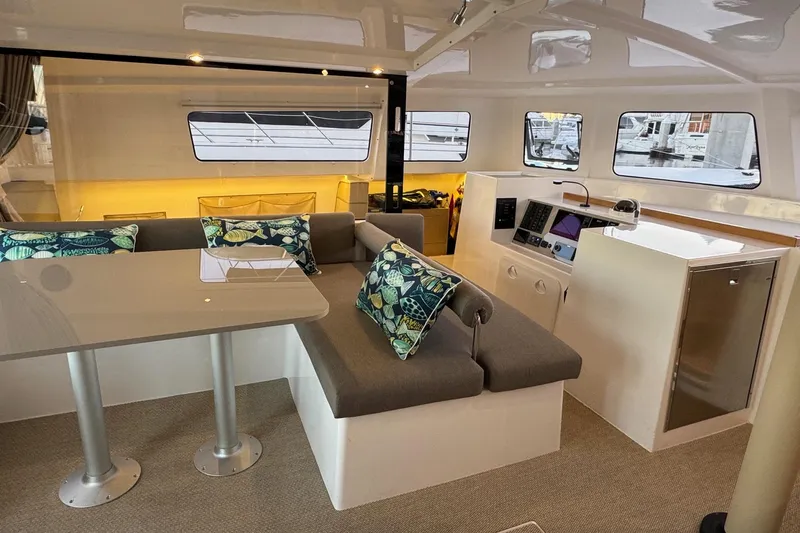 Keizan Yacht Photos Pics Luxurious interior of 2023 NEEL 43 yacht with modern seating and navigation area.