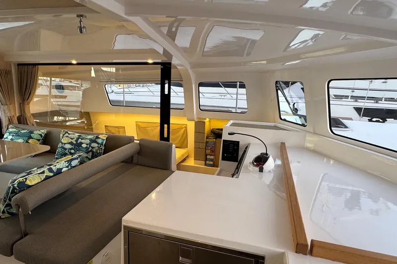 Keizan Yacht Photos Pics Interior of 2023 NEEL 43 yacht with modern seating and large windows.