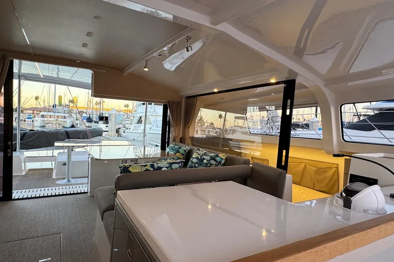 Keizan Yacht Photos Pics Luxurious interior of 2023 NEEL 43 yacht with marina view and modern furnishings.
