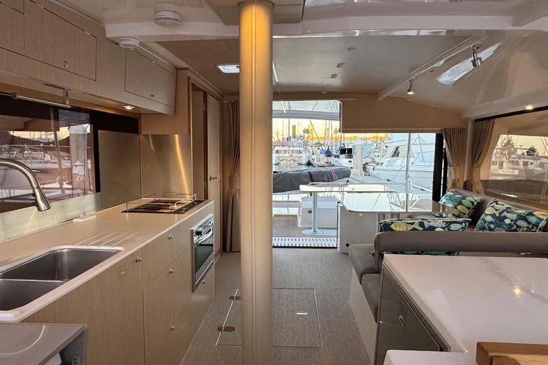 Keizan Yacht Photos Pics Luxurious interior of 2023 NEEL 43 yacht with modern kitchen and seating area.
