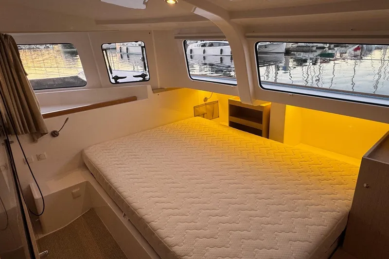Keizan Yacht Photos Pics Luxurious cabin interior of 2023 NEEL 43 with large bed and scenic windows.
