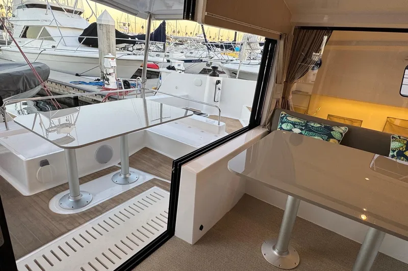 Keizan Yacht Photos Pics Modern NEEL 43 trimaran interior and deck with sleek tables, 2023 model.