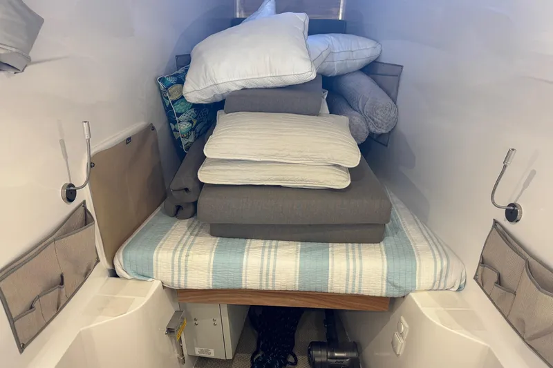 Keizan Yacht Photos Pics Interior cabin of 2023 NEEL 43 with stacked bedding and pillows.