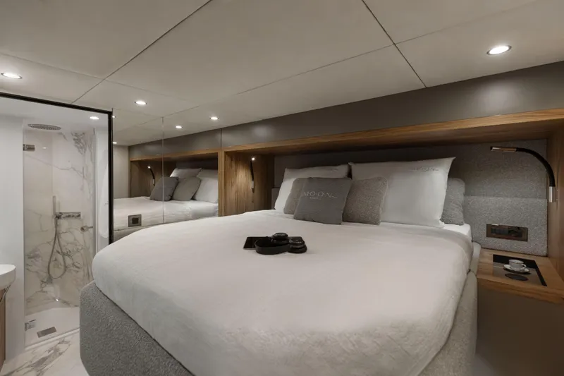  Yacht Photos Pics Luxurious bedroom in 2025 Moon 65 yacht with modern design and elegant bathroom.
