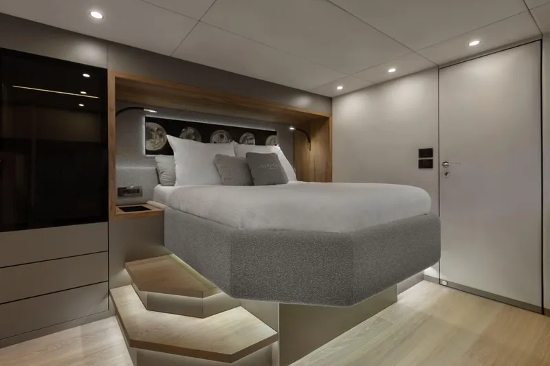 Yacht Photos Pics Luxurious bedroom interior in Moon 65 yacht, 2025 model, featuring modern design and ambient lighting.