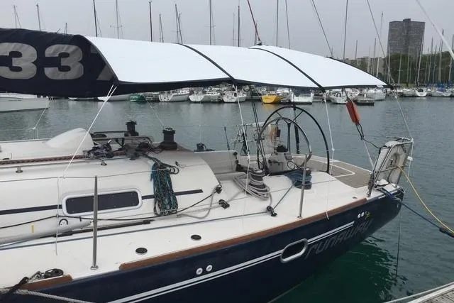 Runaway Yacht Photos Pics Sailboat Elan 40, 2005 model, docked in marina with canopy and visible rigging.