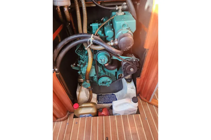 Runaway Yacht Photos Pics Engine compartment of a 2005 Elan 40 sailboat, featuring hoses and containers.