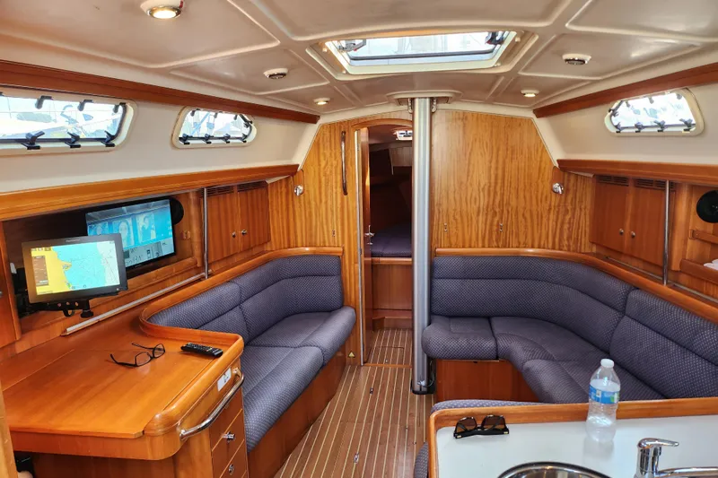 Runaway Yacht Photos Pics Interior of a 2005 Elan 40 yacht with cozy seating and navigation equipment.