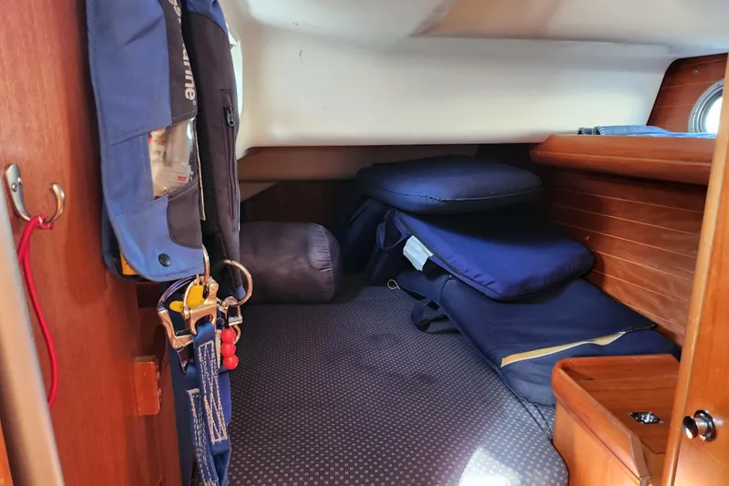 Runaway Yacht Photos Pics Cozy cabin interior of a 2005 Elan 40 sailboat with cushions and hanging gear.