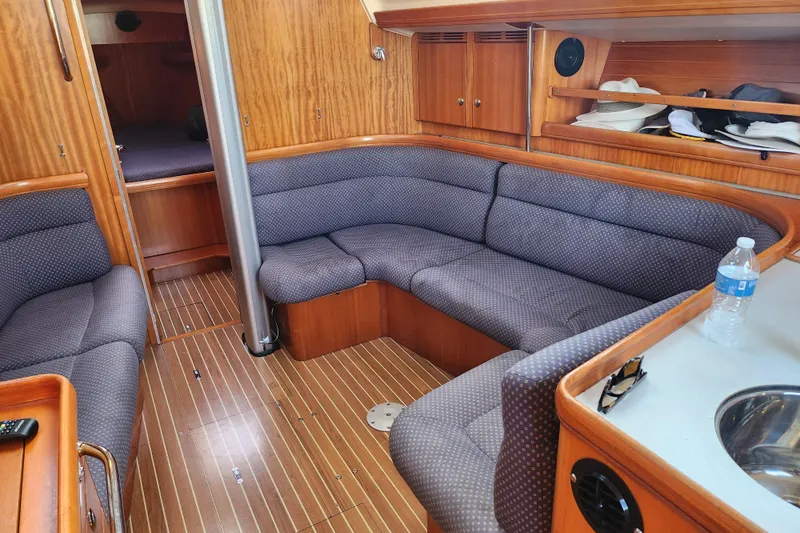 Runaway Yacht Photos Pics Interior of 2005 Elan 40 yacht with cozy seating and wooden finish.