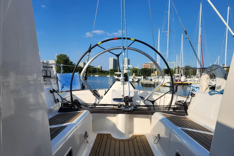 Runaway Yacht Photos Pics Cockpit view of 2005 Elan 40 sailboat docked in a marina with clear blue sky.
