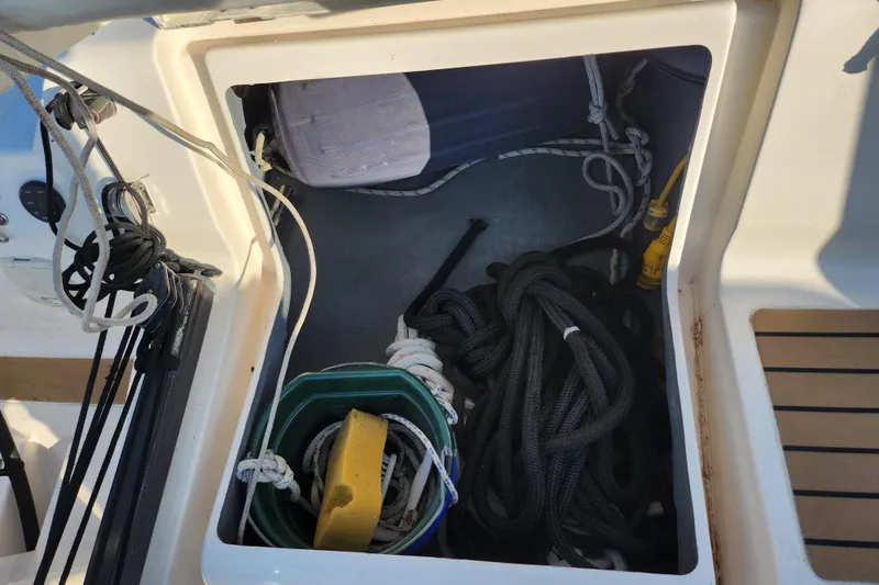 Runaway Yacht Photos Pics Storage compartment on a 2005 Elan 40 sailboat with ropes and cleaning supplies.