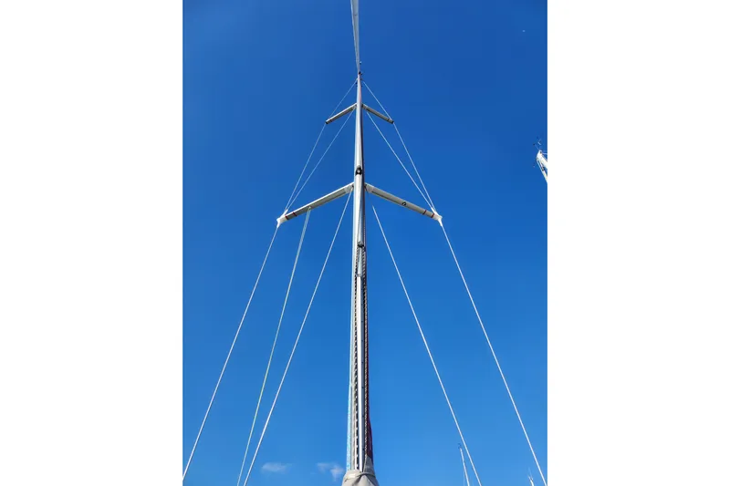 Runaway Yacht Photos Pics Mast of 2005 Elan 40 sailboat against clear blue sky.