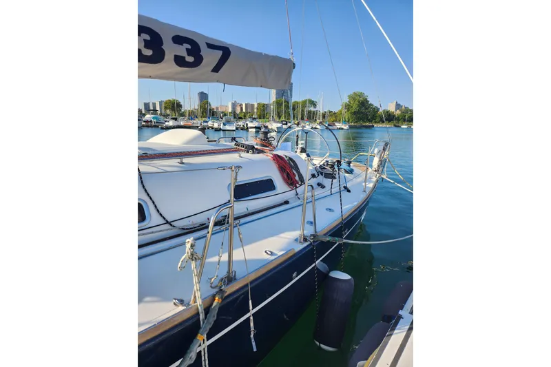 Runaway Yacht Photos Pics Sailboat Elan 40, 2005 model, docked in a marina with clear blue water.