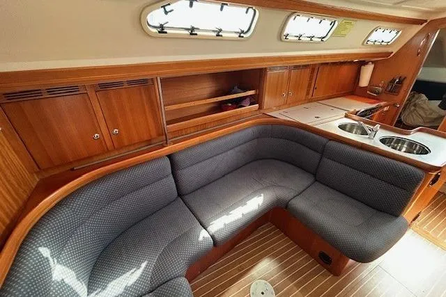 Runaway Yacht Photos Pics Luxurious interior of a 2005 Elan 40 yacht with wooden cabinetry and plush seating.