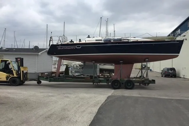 Runaway Yacht Photos Pics Sailboat Elan 40 (2005) on trailer, transported by forklift in marina setting.