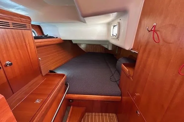 Runaway Yacht Photos Pics Cozy cabin interior of 2005 Elan 40 sailboat with wooden finish and comfortable bedding.