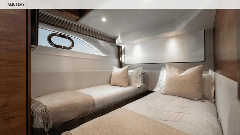 Amussay Yacht Photos Pics Luxurious twin cabin interior of 2020 Princess F62 yacht with elegant bedding and modern design.