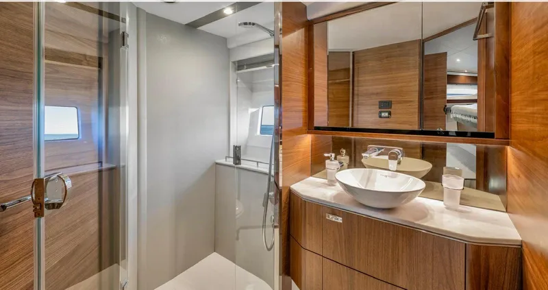 Amussay Yacht Photos Pics Luxurious bathroom in 2020 Princess F62 yacht with modern fixtures and wooden accents.