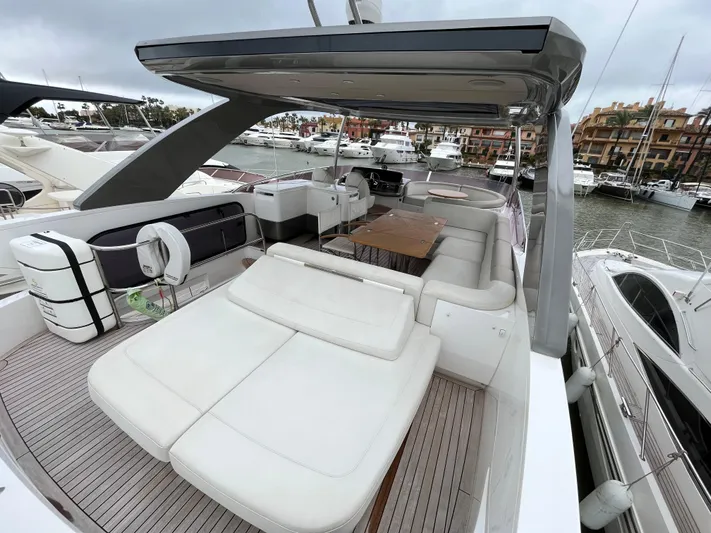 Amussay Yacht Photos Pics Luxurious 2020 Princess F62 yacht with spacious deck and seating area in marina.
