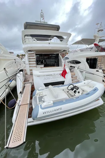 Amussay Yacht Photos Pics 2020 Princess F62 yacht with tender, docked in marina under cloudy skies.