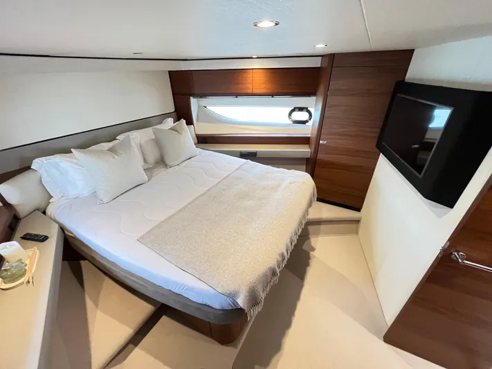 Amussay Yacht Photos Pics Luxurious bedroom interior of 2020 Princess F62 yacht with modern design and cozy bedding.