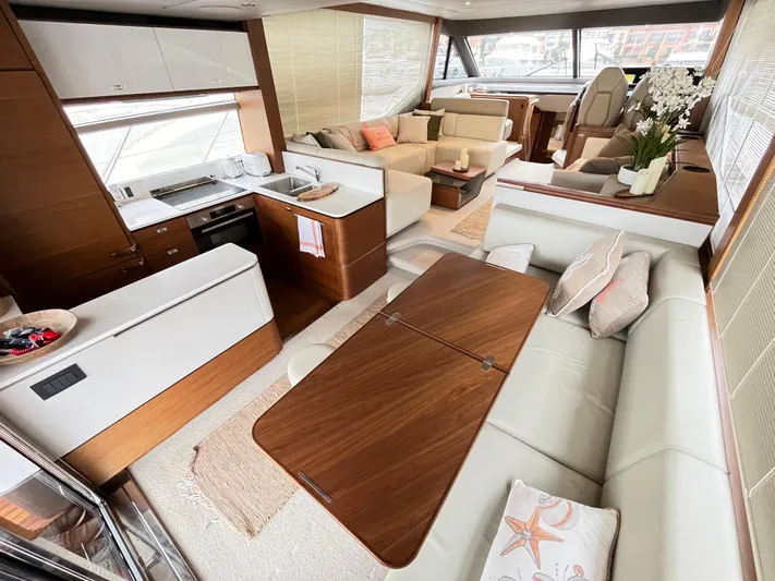 Amussay Yacht Photos Pics Luxurious interior of 2020 Princess F62 yacht with modern kitchen and elegant seating area.