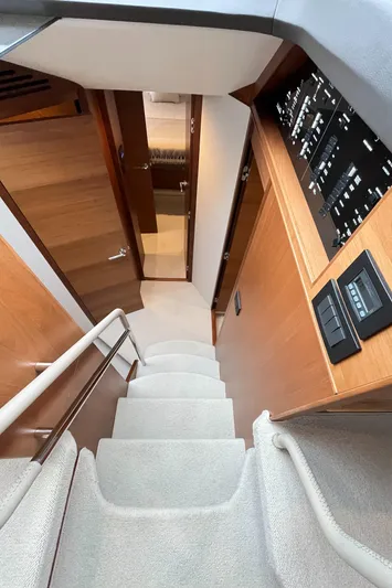 Amussay Yacht Photos Pics Interior view of 2020 Princess F62 yacht, featuring a staircase and control panels.