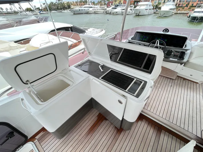 Amussay Yacht Photos Pics Outdoor kitchen on 2020 Princess F62 yacht with grill and sink, docked at marina.