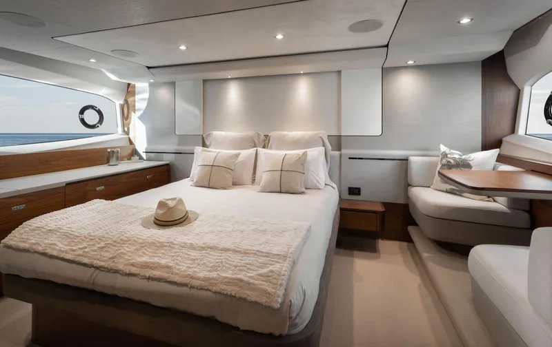 Amussay Yacht Photos Pics Luxurious bedroom interior of 2020 Princess F62 yacht with elegant furnishings and ambient lighting.
