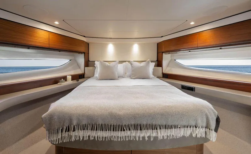 Amussay Yacht Photos Pics Luxurious bedroom interior of 2020 Princess F62 yacht with ocean view windows.