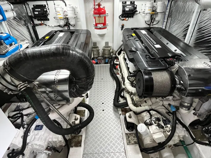 Amussay Yacht Photos Pics Engine room of a 2020 Princess F62 yacht, featuring dual engines and safety equipment.