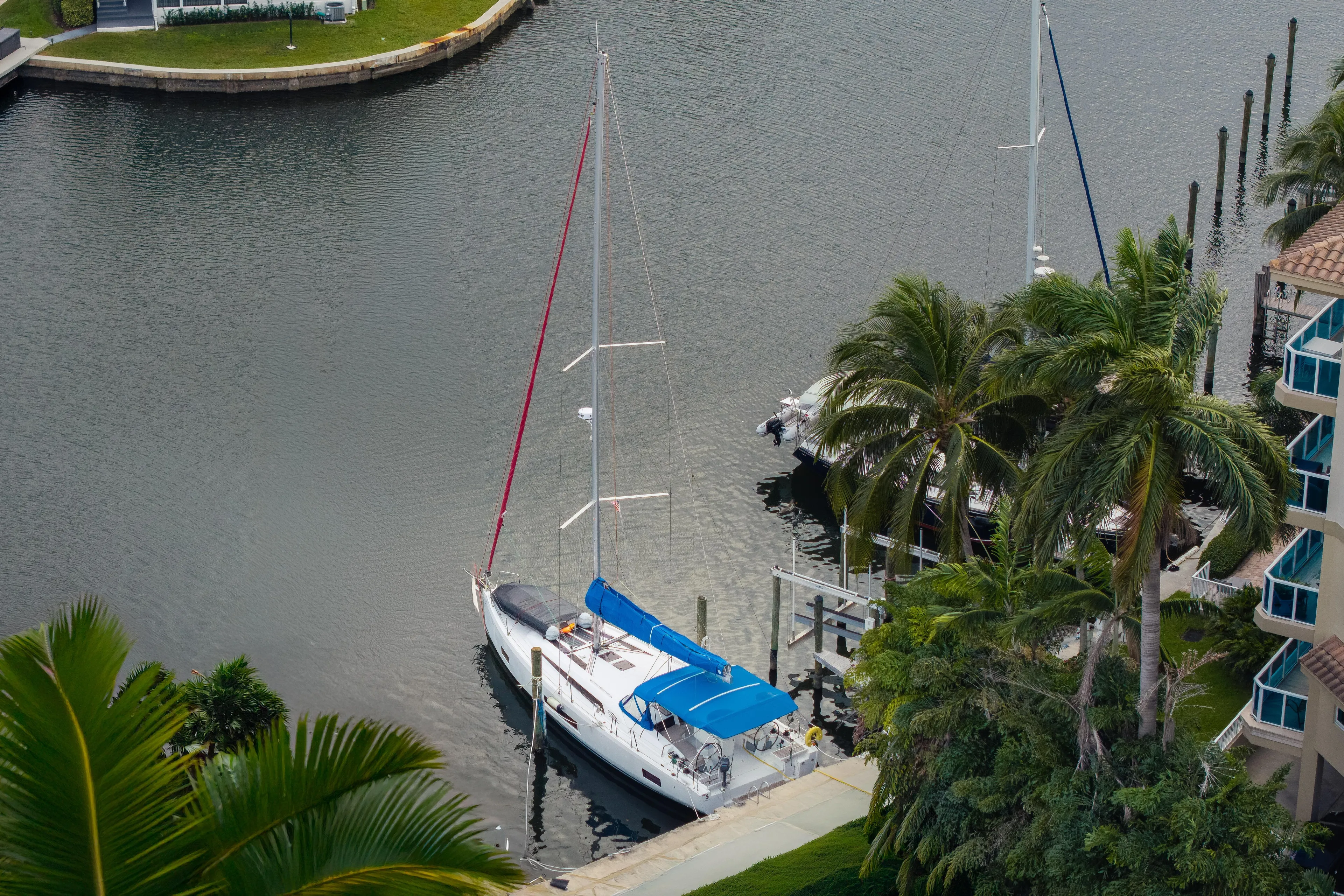 Siman H Yacht Photos Pics 2020 Beneteau Oceanis 46.1 sailboat docked near palm trees in a serene marina.