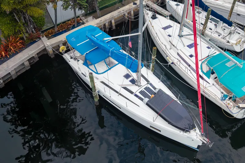 Siman H Yacht Photos Pics 2020 Beneteau Oceanis 46.1 sailboat docked, featuring blue covers and sleek design.