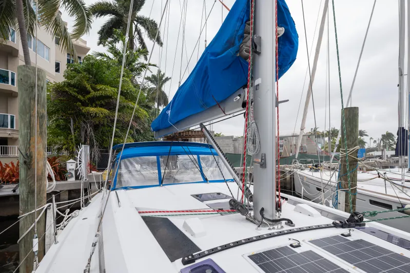 Siman H Yacht Photos Pics 2020 Beneteau Oceanis 46.1 sailboat docked, featuring blue sail cover and solar panels.