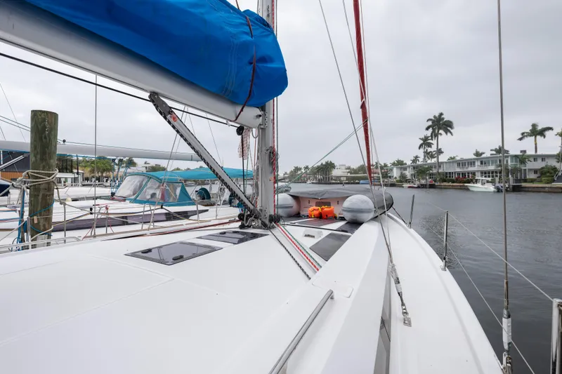 Siman H Yacht Photos Pics 2020 Beneteau Oceanis 46.1 sailboat docked in a marina, featuring a blue sail cover.
