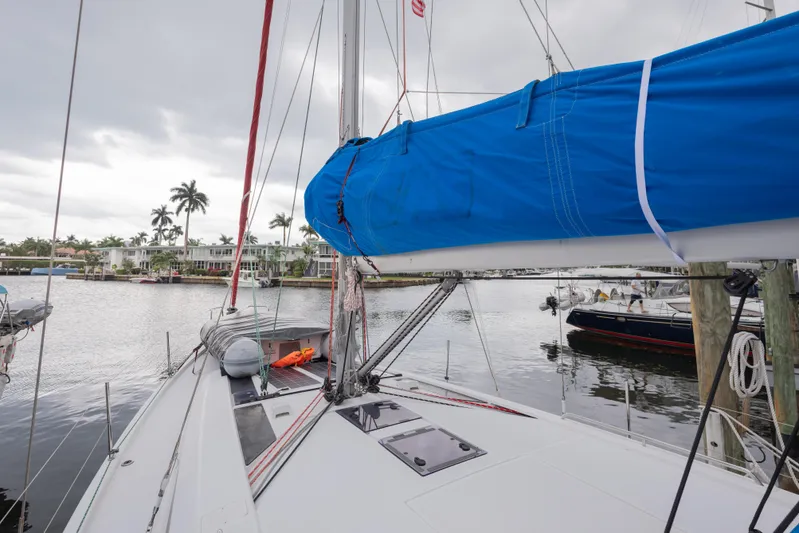 Siman H Yacht Photos Pics 2020 Beneteau Oceanis 46.1 sailboat docked in a marina with palm trees.