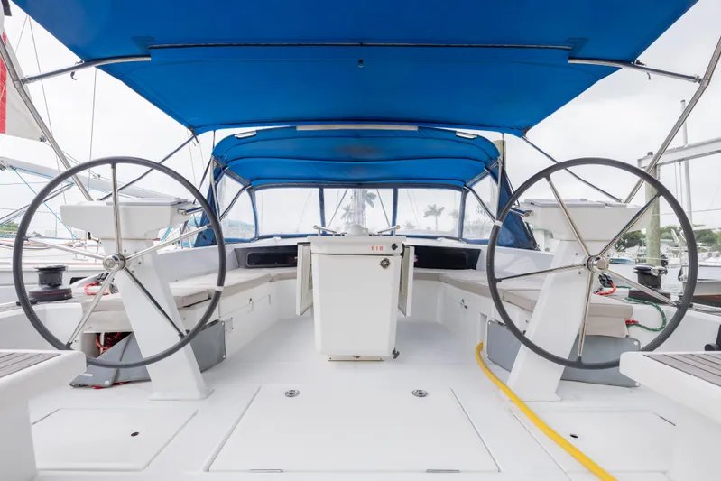 Siman H Yacht Photos Pics 2020 Beneteau Oceanis 46.1 yacht cockpit with dual steering wheels and blue canopy.