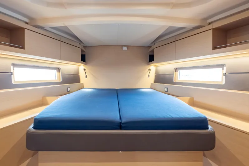 Siman H Yacht Photos Pics Luxurious cabin interior of 2020 Beneteau Oceanis 46.1 yacht with blue bedding.