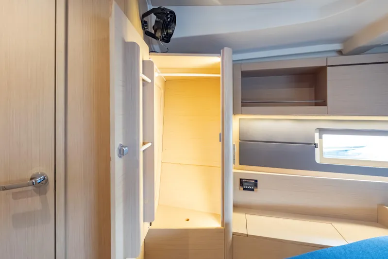 Siman H Yacht Photos Pics Interior of 2020 Beneteau Oceanis 46.1 yacht, featuring modern wood cabinetry and window.