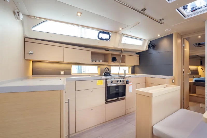 Siman H Yacht Photos Pics Modern kitchen interior of 2020 Beneteau Oceanis 46.1 yacht, featuring sleek cabinetry and appliances.
