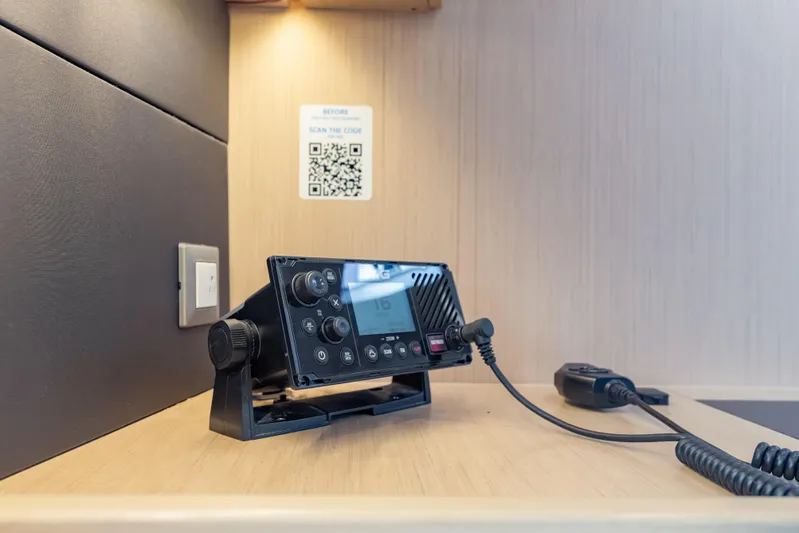 Siman H Yacht Photos Pics VHF radio on Beneteau Oceanis 46.1 yacht, 2020 model, with QR code on wall.