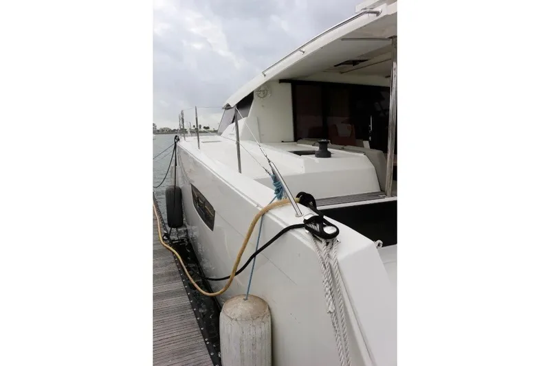 Cloud Nine Yacht Photos Pics 2020 Fountaine Pajot Astrea 42 Catamaran docked, side view with mooring lines.